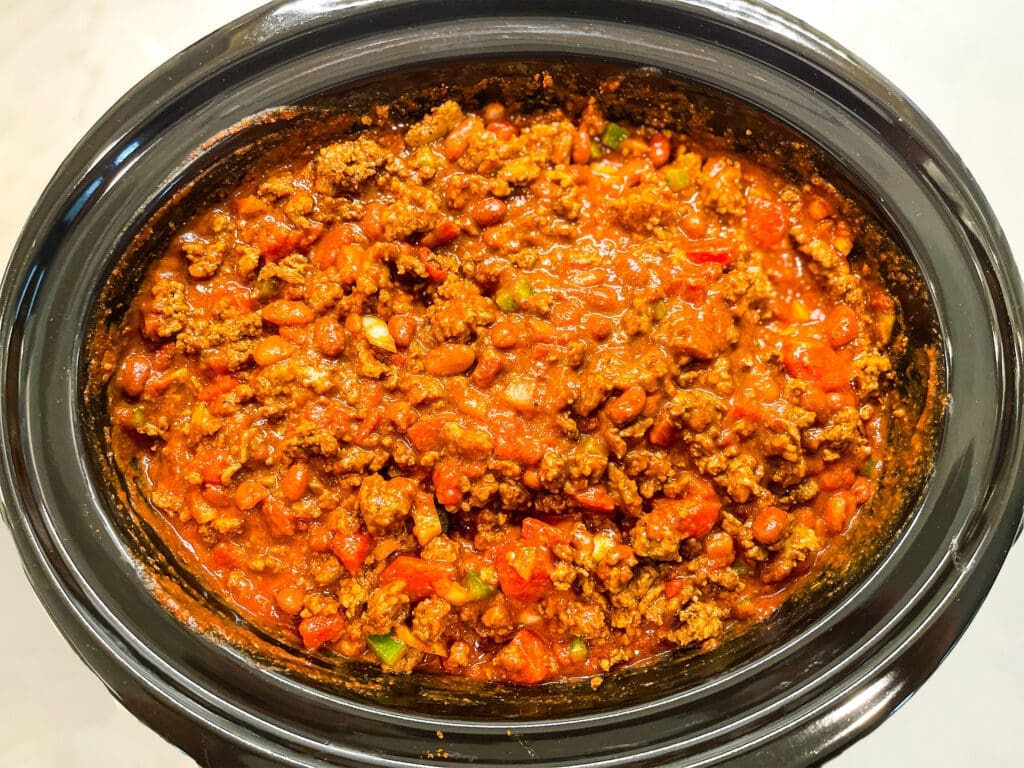 Photo of uncovered crockpot chili recipe together in the pot prior to cooking