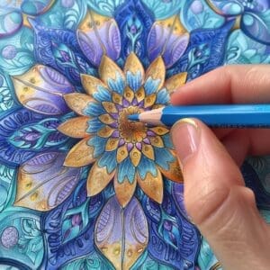 A mandala adult coloring page with a hand coloring with a blue colored pencil